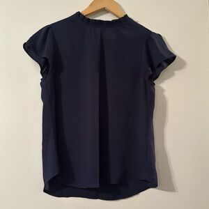 Navy blouse with feminine ruffled neckline, and cap sleeves size small